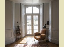 Painted panelled room with glazed doors